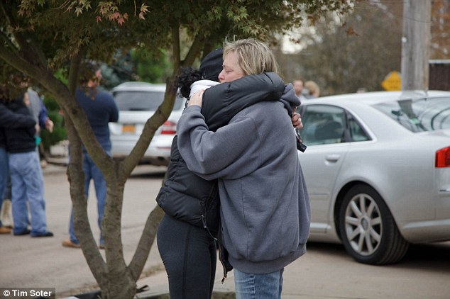 'He was my rock': Christine Filipowicz hugs a friend outside her house