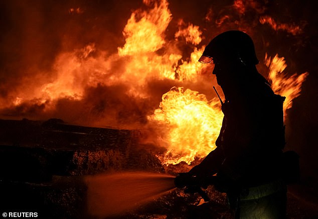 A firefighter works at the scene of a Russian drone strike in Kharkiv, Ukraine, on February 10, 2024.