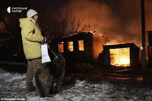 A woman, Natalia, in front of a house burned down after the night strike in Kharkiv.