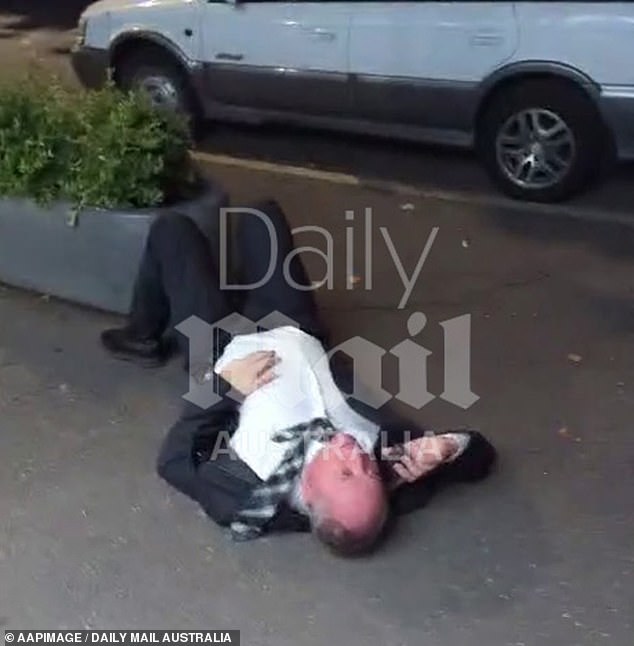 Daily Mail Australia revealed exclusive video of the country's former deputy prime minister lying on the sidewalk (pictured) in Canberra on Wednesday night.