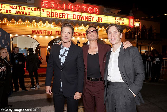 The handsome actors posed outside the theater.