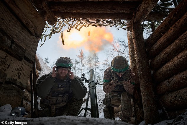 Soldiers of a mortar platoon with an 82 mm mortar perform a combat mission while Ukrainian soldiers maintain their positions in the snowy Serebryan forest in temperatures of -15 °C, January 2024 in Kreminna, Ukraine.