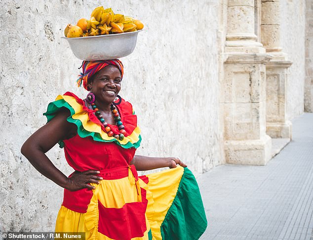 Boardwalks and forest trails lead to beaches where edible sea grapes grow and tamarins peer out from palm trees, Kate writes. Above, a fruit seller in Cartagena.