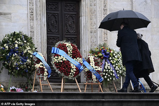 Her funeral, which will take place at the Cathedral of St. John the Baptist in northern Italy, appears to be an opulent event, with extravagant flower arrangements at the door.