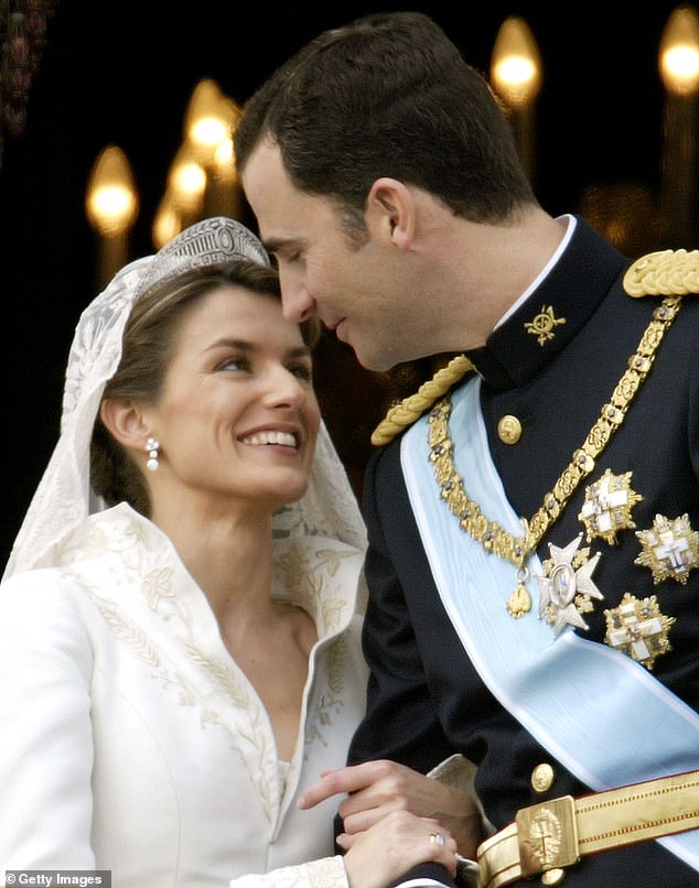 Spanish Crown Prince Felipe de Borbón and his girlfriend Letizia look at each other as the royal couple appears on the balcony of the Royal Palace on May 22, 2004.