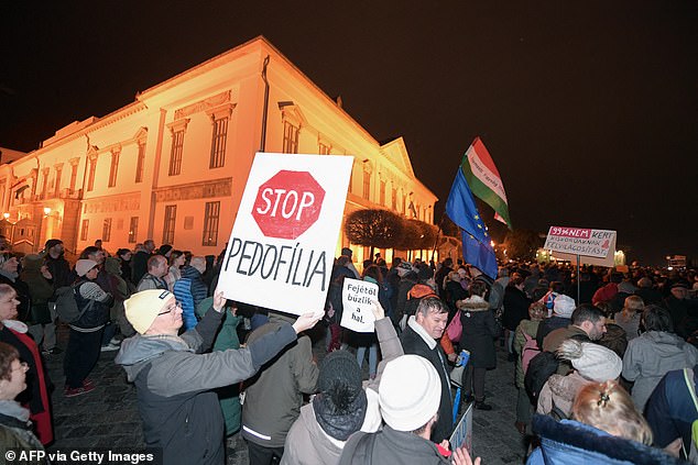 Protesters with banners take part in a demonstration in Budapest in front of the presidential offices.