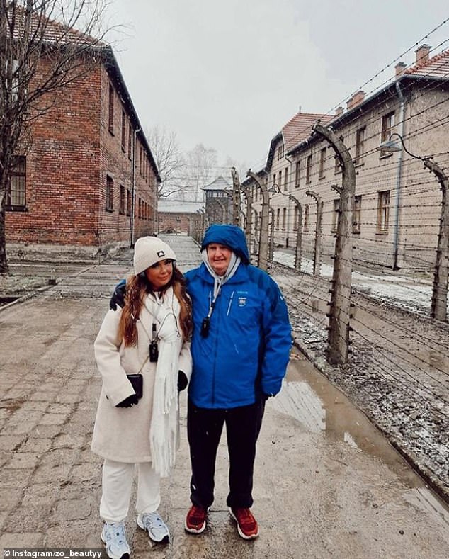 Zoe, from Ireland, smiled during a photo next to the metal bars of the former concentration and extermination camp and described the experience as 