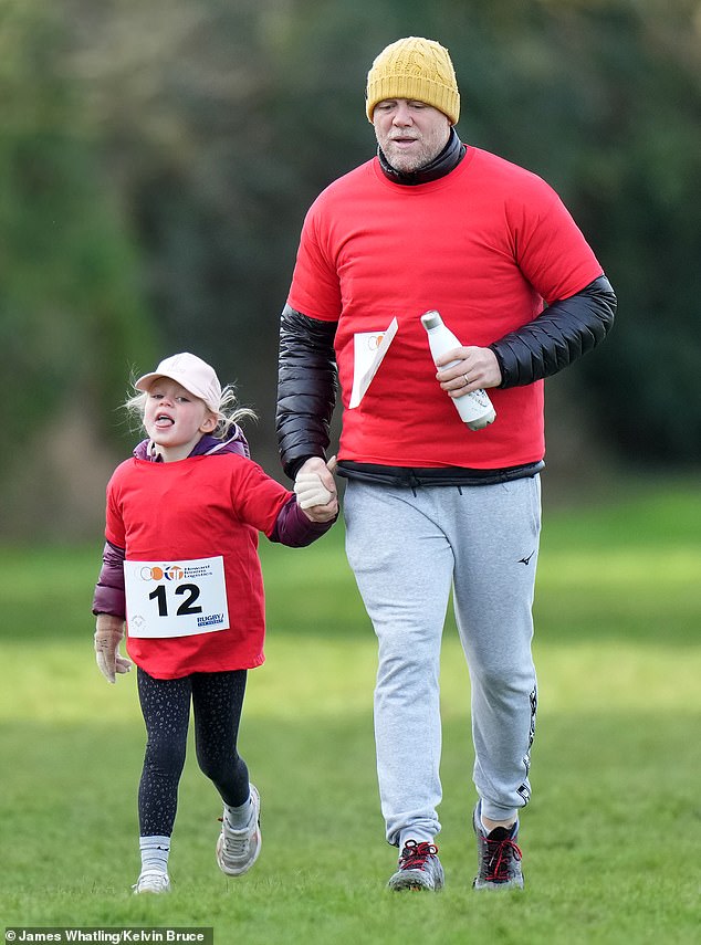 The former England rugby international, 45, looked in high spirits as he jogged alongside his excited youngster at the Rugby for Heroes event at Old Richians RFC in Gloucester.