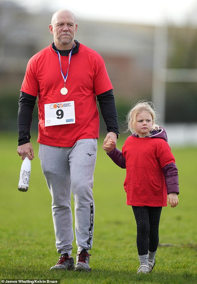 Mike, who is married to the King's niece Zara Tindall, 42, sported a bright red t-shirt that matched his daughter's, while they both had papers showing their race number pinned to their shirts during the race .