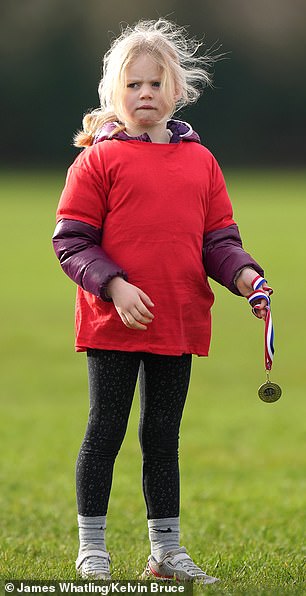 In addition to her bright red t-shirt, Lena sported a purple coat and black printed leggings, with pink sneakers.