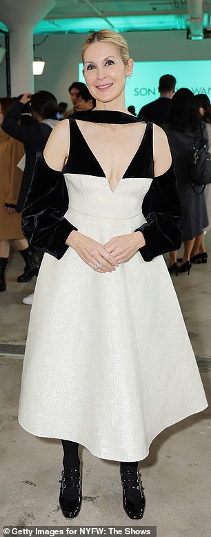 The artist donned a flowy white dress with jet black straps before heading to Son Jung Wan's show.