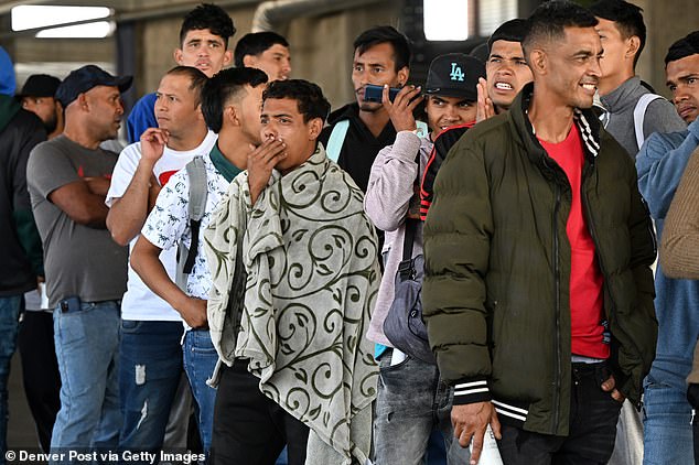 Denver city officials warn that the 38,464 migrants they have served since the end of 2022 are increasing every day. Pictured: Venezuelan migrants wait in line to obtain documents needed to be admitted to shelters at a migrant processing center on May 9, 2023 in Denver, Colorado.