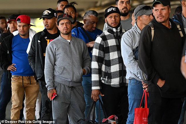 Venezuelan migrants wait in line to obtain paperwork to be admitted to shelters at a migrant processing center on May 9, 2023 in Denver, Colorado.
