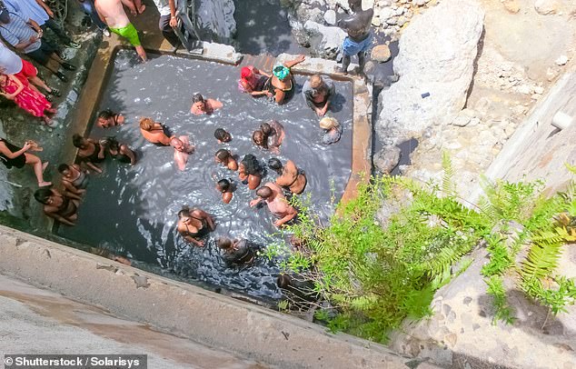 Above, visitors take a mud bath in the sulfurous hot springs of Santa Lucia.