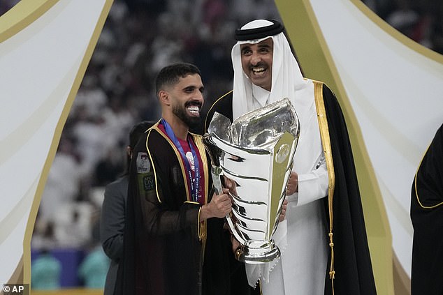 Hasan Al Haydos of Qatar receives the trophy from the Emir of Qatar, Tamim bin Hamad Al Thani