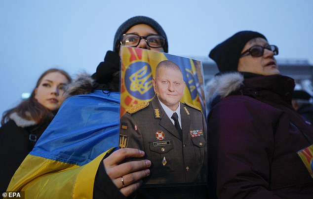 A woman holds a photograph of the former commander-in-chief of the Armed Forces of Ukraine, Valerii Zaluzhnyi, during a rally in support of him on Independence Square in kyiv.