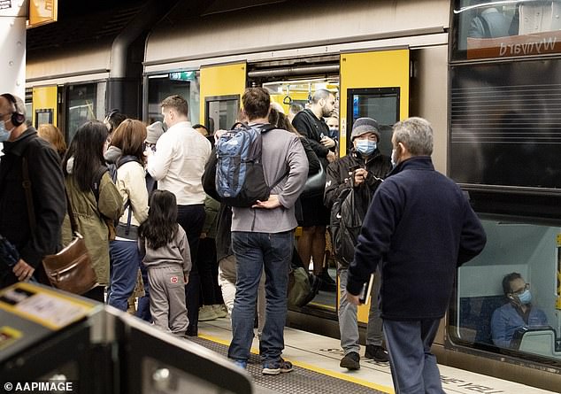 Rising immigration is now expected to push up house prices, with Westpac forecasting a double-digit rise in 2023 for Sydney despite 12 Reserve Bank interest rate rises in just over a year (pictured, Wynyard train station during rush hour).