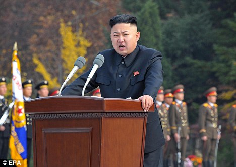 Monuments: Kim Jong-un delivers a speech during a ceremony to unveil statues of his grandfather Kim Il-sung and father Kim Jong-il (below)