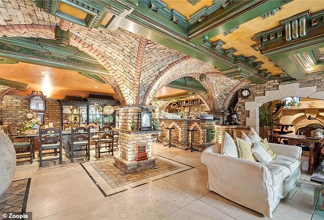 The interior also has a castle theme and the main living room features a vaulted sloping brick ceiling.