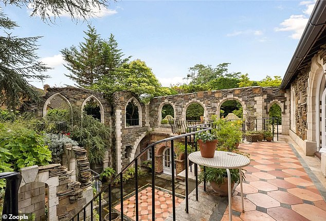 The unusual property has some terraces offering views of the large tiled patio.