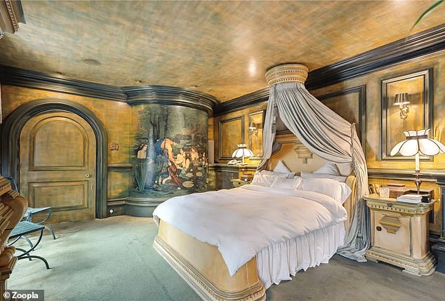 This double bedroom has colorful walls and ceilings, including a mural with some nudes in the water.