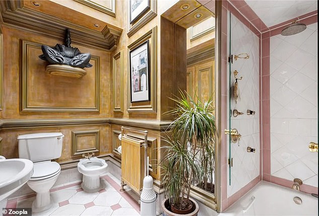 The property has six bathrooms, including this one with a waterfall shower, bidet and wood paneling on the walls.