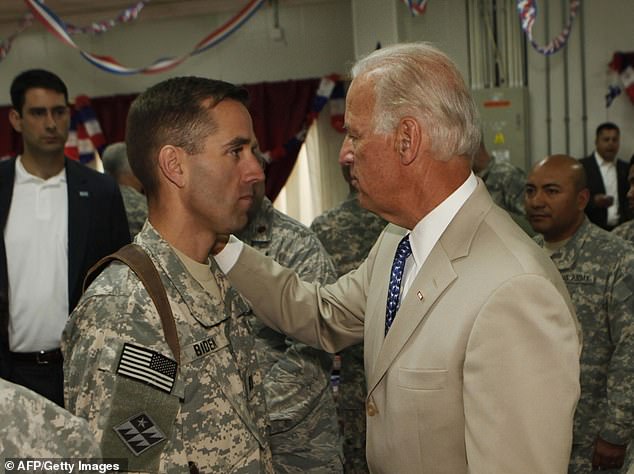 Biden is seen visiting his son, U.S. Army Capt. Beau Biden, at Camp Victory, outside Baghdad, July 4, 2009. Beau served in the Delaware Army National Guard before launching his own career policy.