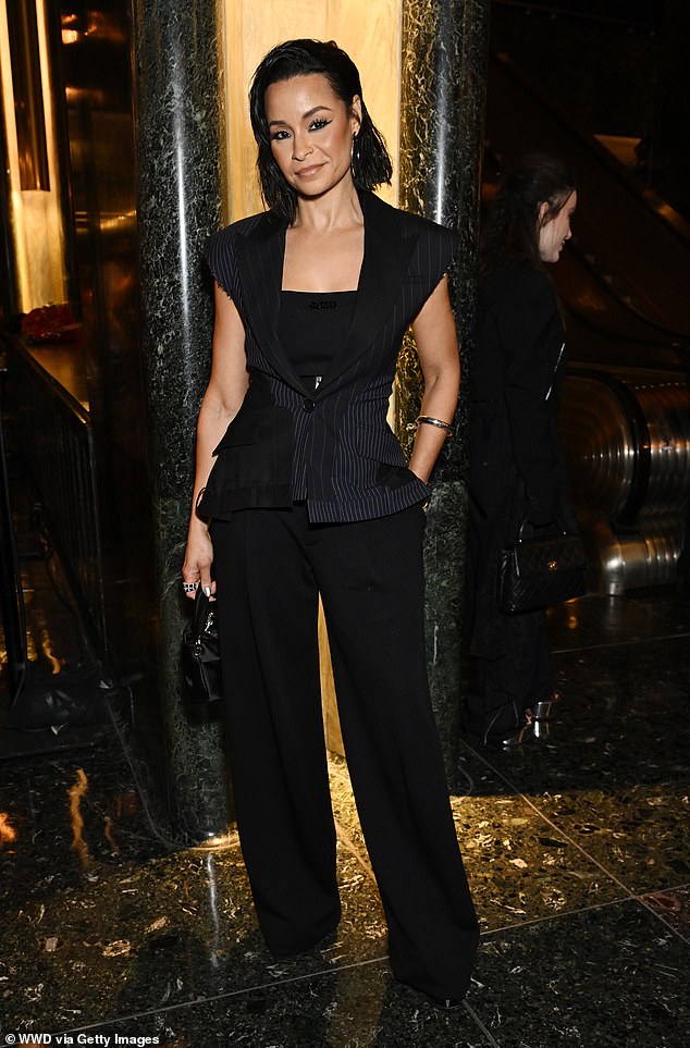 Sai De Silva, 43, posed in her elegant black ensemble near the escalators where models would descend during the Monse show.