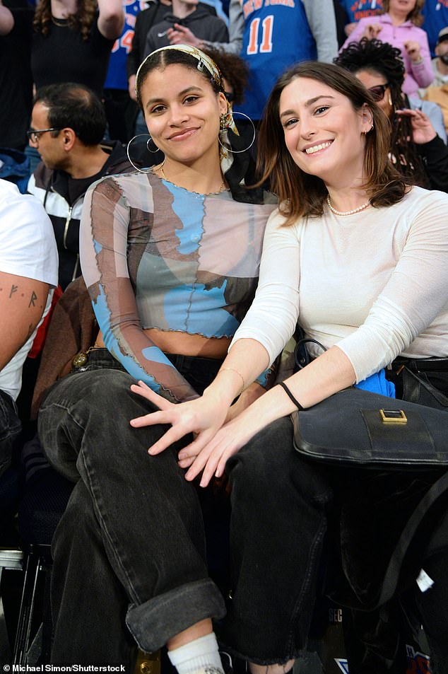 Zazie Beetz (left) appeared to be in high spirits as she held a big smile on her face while rocking a semi-sheer printed top and a pair of gray jeans while sitting next to a close friend.