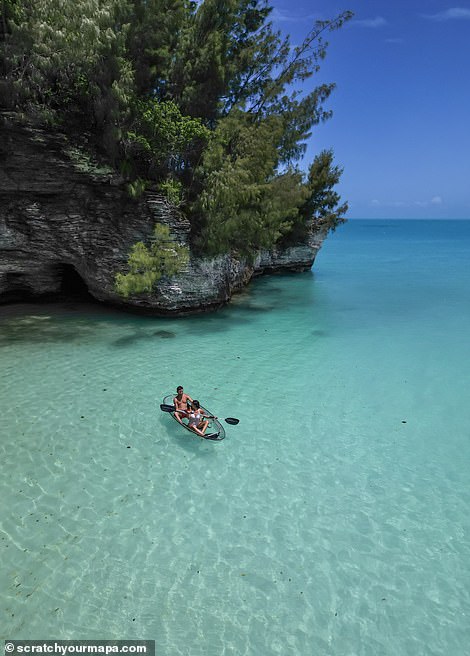 The couple is shown here in a clear canoe enjoying the blue waters of Spanish Point, Bermuda.