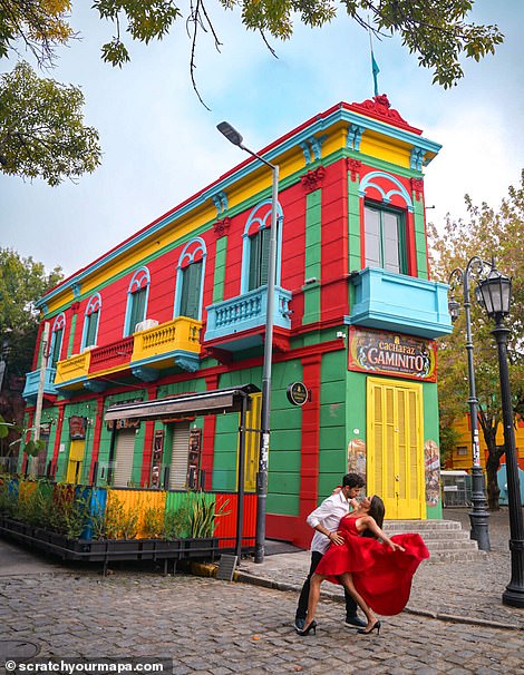 The couple poses in front of a colorful wall at Caminito, an open-air museum and traditional alley in La Boca, a neighborhood in Buenos Aires.