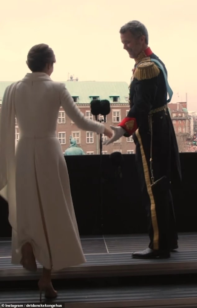 The footage then jumps to Queen Mary walking onto the balcony to join her husband and wave to the crowd of royal fans.