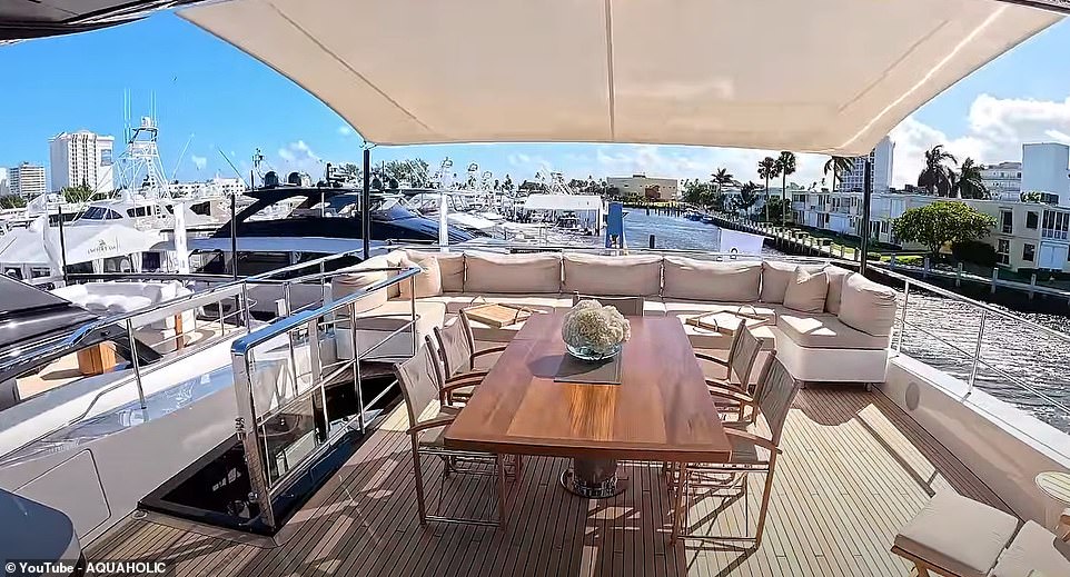 An outdoor area at the rear of the yacht works well as an entertainment venue, with a dining table and sofas set up.