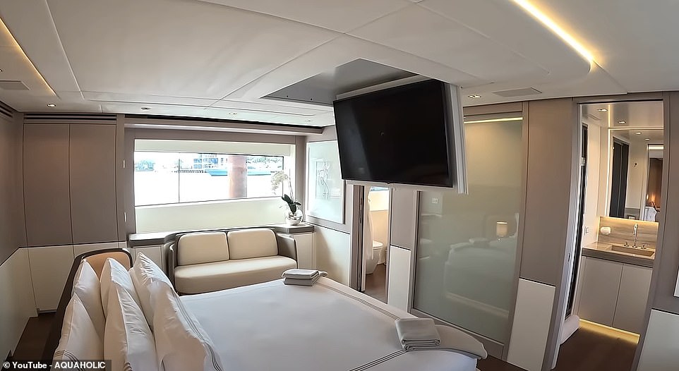 The piece de resistance is the owner's cabin with a giant center bed, a TV that folds down from the ceiling, and two bathroom spaces with a huge shower connecting the two bathrooms in the middle.