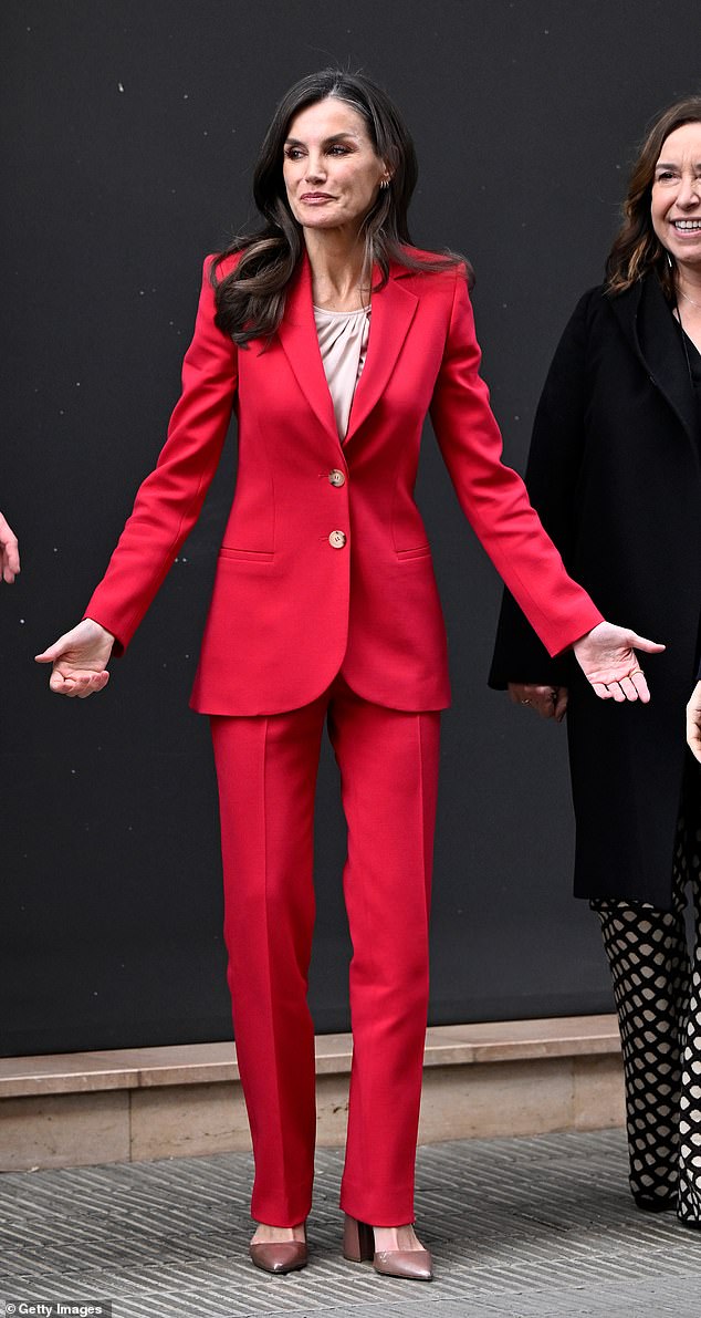 The Queen was dressed appropriately for the groundbreaking experience in a scarlet power suit, which she introduced to her wardrobe last March.