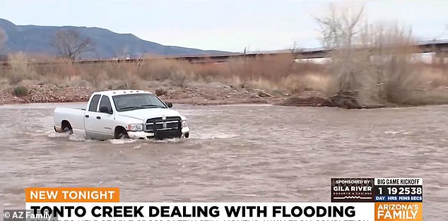 A white pickup truck trapped in flood waters near Tonto Creek in Arizona on Friday. Excess water left many drivers trapped on nearby roads.