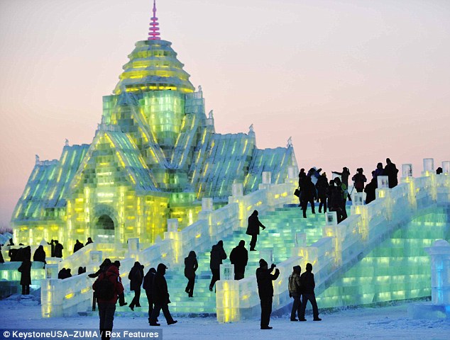 Slippery slope: Visitors are dwarfed by gigantic ice architecture