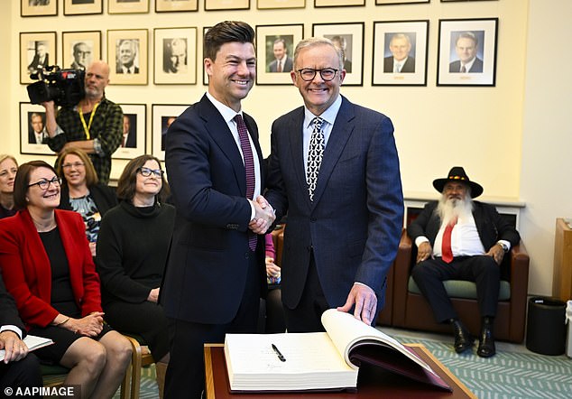 Australian Prime Minister Anthony Albanese congratulates Hawke Labor member Sam Rae after signing the Labor caucus book.