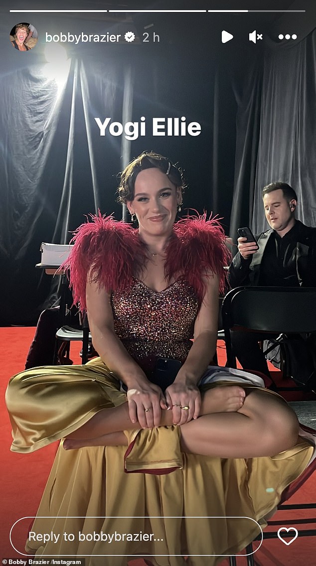 She couldn't wipe the smile off her face when Bobby was caught off guard and captioned the post 'yogi Ellie', as she sat cross-legged.