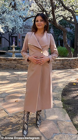 Jenna covered her growing baby bump with a beige trench coat over thigh-high snakeskin boots.