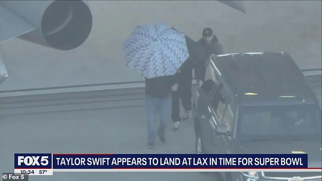 Swift was protected by an umbrella when she landed in Los Angeles on Saturday afternoon.