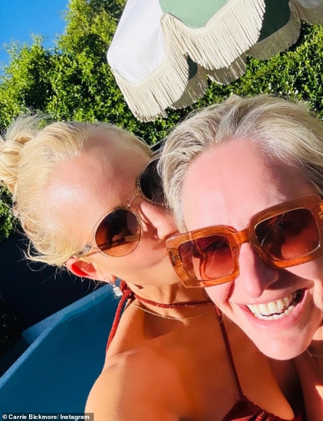 The ageless beauty showed off her best angles in a black string bikini as she posed with friends, including her radio star BFF, Fifi Box (pictured right).