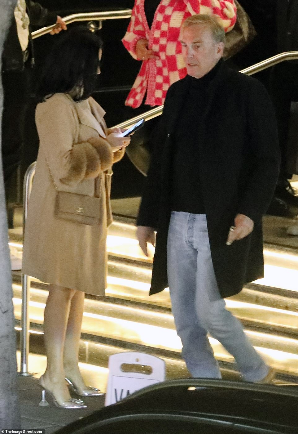 Costner was seen leaving separately before standing near a mystery woman wearing Cinderella shoes.