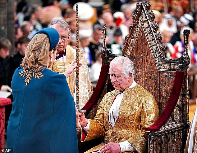 The Lord President of the Council, Penny Mordaunt, presents the Sword of State to King Charles III, during the coronation ceremony of King Charles III and Camilla, the Queen Consort, at Westminster Abbey on Saturday.