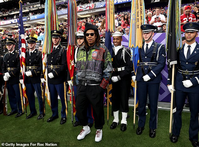 The Empire State Of Mind artist was photographed in front of a row of military officers.
