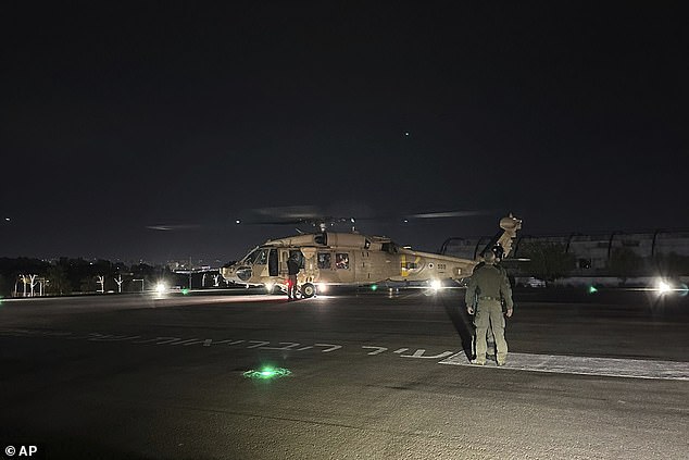 This photo provided by the Israeli military shows an Israeli Air Force helicopter carrying the two hostages.