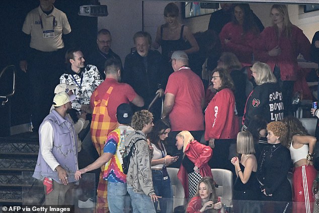 He was also seen being introduced to Philadelphia Eagles center Travis Kelce's brother Jason Kelce (red and yellow jumpsuit) in the suite.