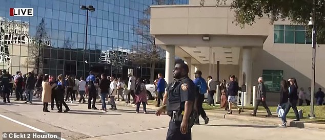 A woman in a trench coat walked into famed pastor Joel Osteen's Houston megachurch and started shooting Sunday afternoon and was killed by two off-duty security officers, police said.