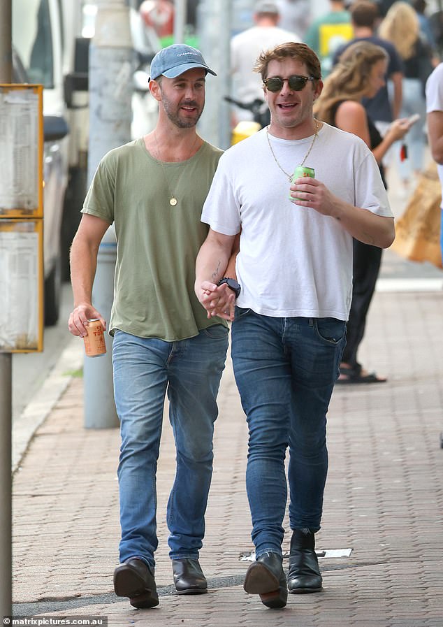 Hugh's handsome new boyfriend also got the blue jeans memo and opted to pair his jeans with an olive green t-shirt and a blue cap. The handsome duo sported facial hair for the outing as they quenched their obvious thirst.