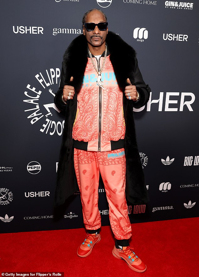 Snoop Dogg turned heads in a pink and red 'Gin & Juice' tracksuit, announcing his new drink inspired by his 2013 hit.